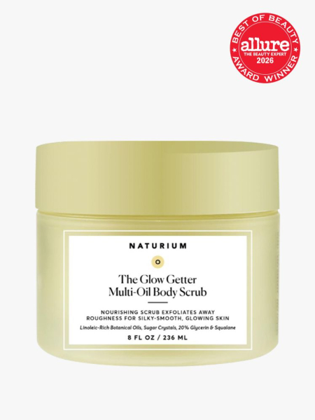 Naturium The Glow Getter Multi-Oil Body Scrub in branded tub component on a light gray background with the 2026 best of beauty seal in the top right corner