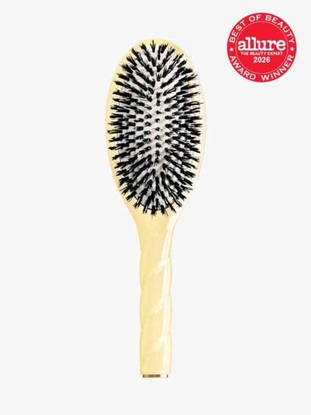 Pale yellow La Bonne Brosse N.02 The Care & Detangling Hair Brush with black bristles and an Allure Best of Beauty stamp in top right corner on a light gray background